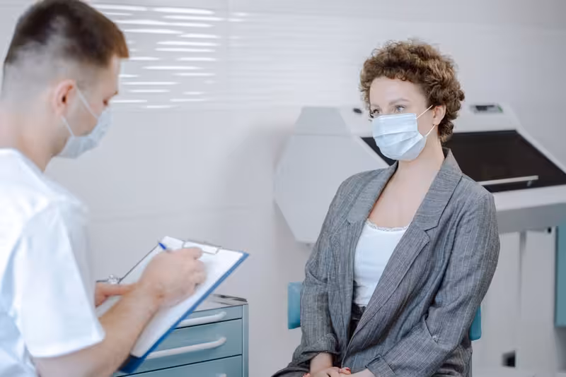 Doctor and patient consultation for How Much Does Ear Wax Removal In Kingston Cost? - Hearing First Kingston Mobile Check-In...